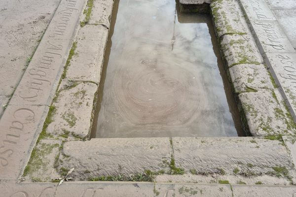 Lines from Burns poetry line the edge of the pool
