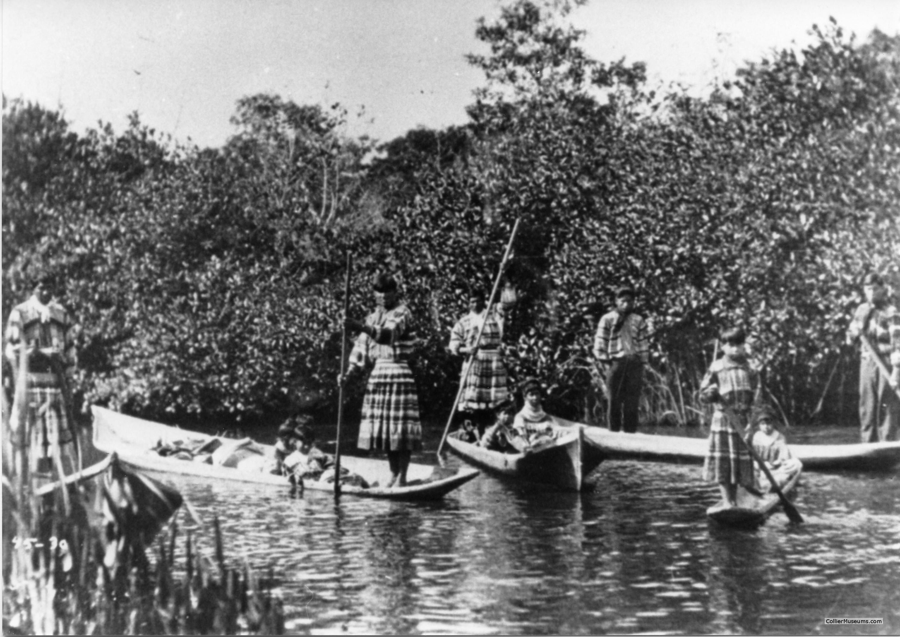 Seminole Indians poling canoes in the Everglades, circa 1930.