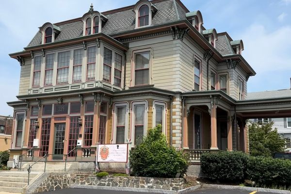 A large Victorian mansion with many windows.