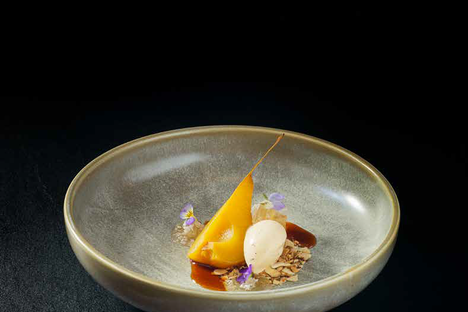 This dessert from Hiakai features pears poached in manono tree bark with horopito (pepper tree) ice cream and almond "soil" made of toasted almonds and crushed biscuits.
