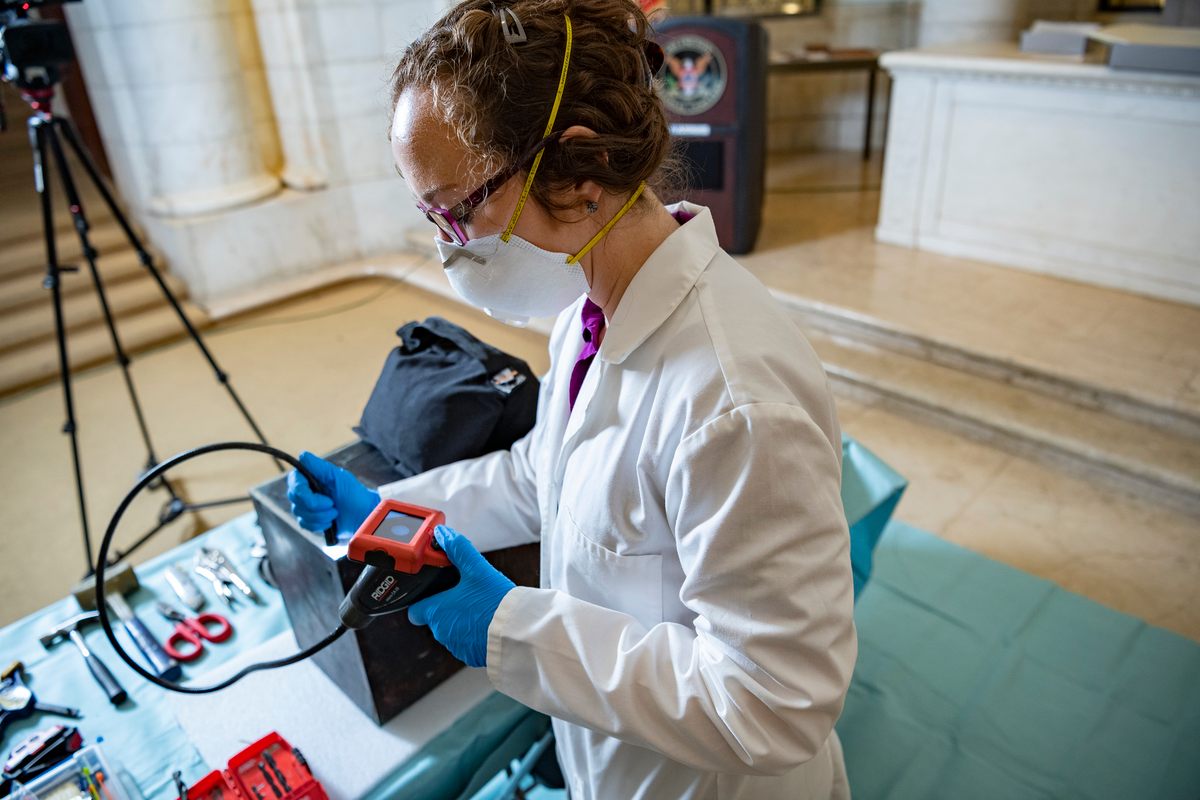 Before the team opened the box, Caitlin Smith, a conservator, drilled small holes in it, then used a borescope to figure out where things were sitting.