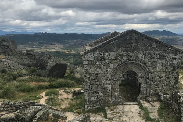 Capela de São Miguel with living rock graves in foreground.