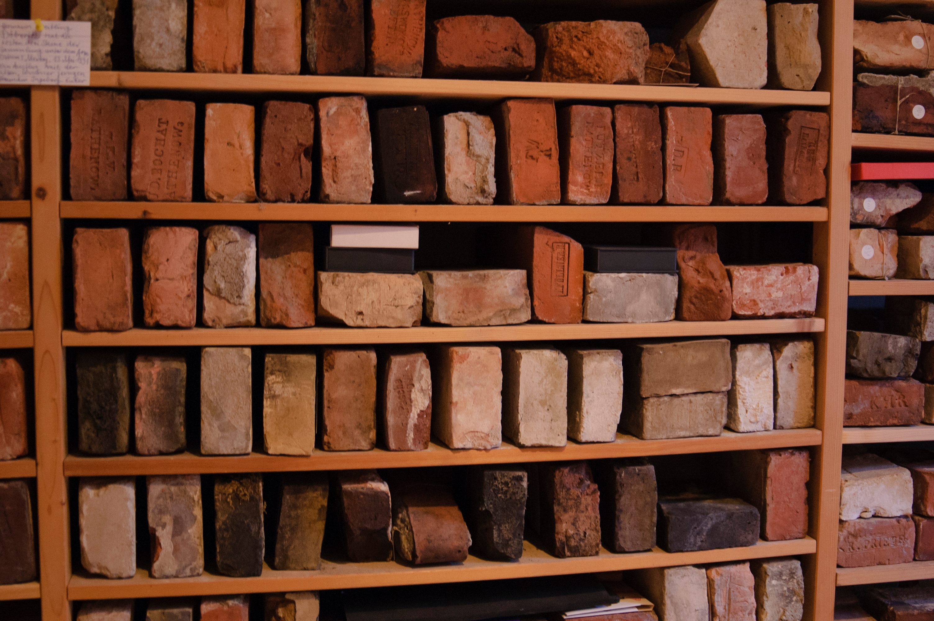 Each brick in Lange’s collection bears its own design and stamp and resides on specially constructed wooden shelves.