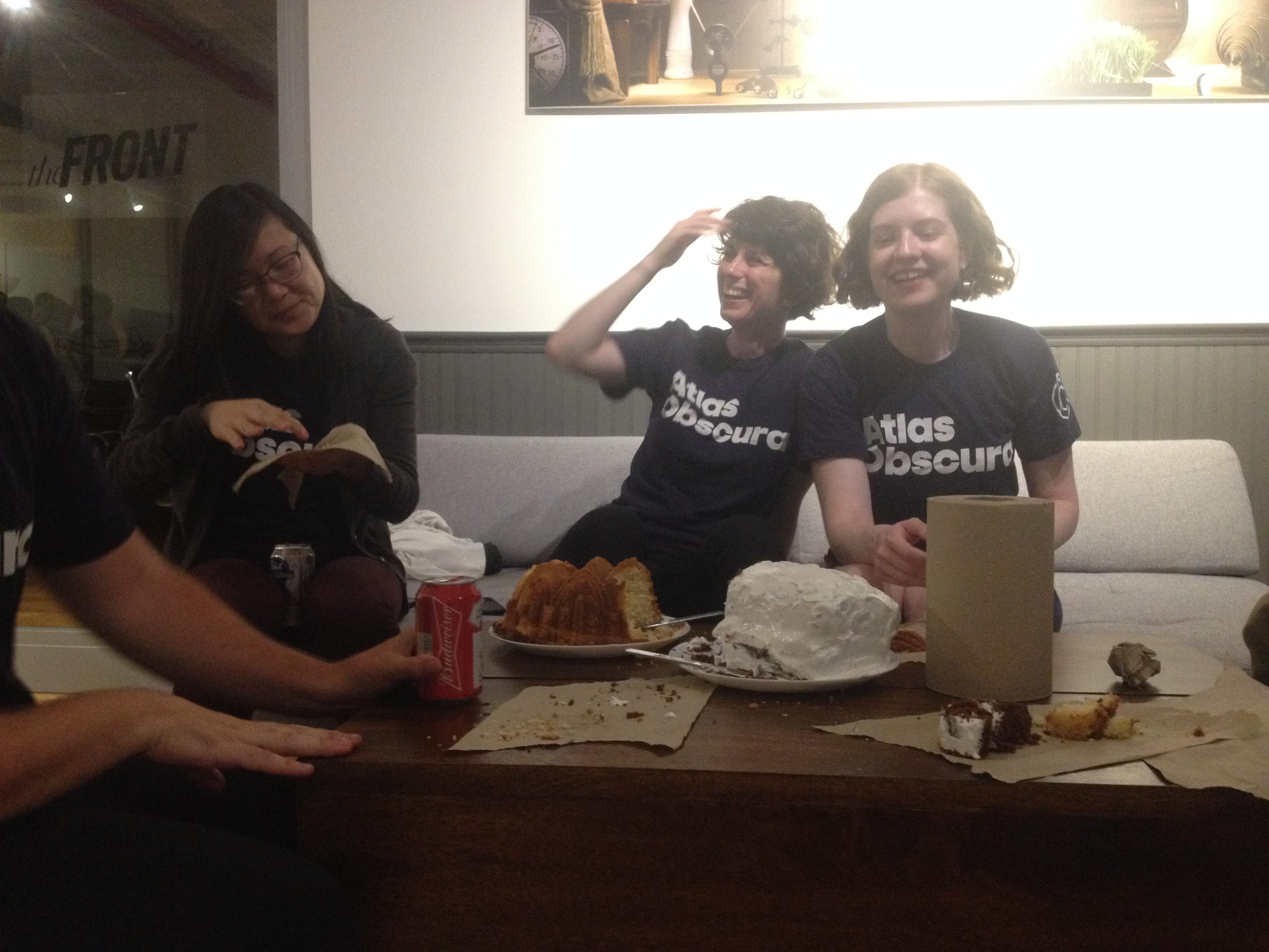 Atlas staffers having fun with cakes.