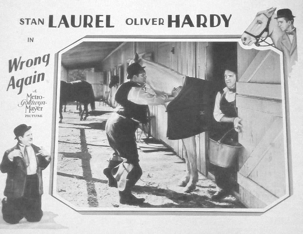 The lobby card for Laurel and Hardy's <em>Wrong Again</em>.