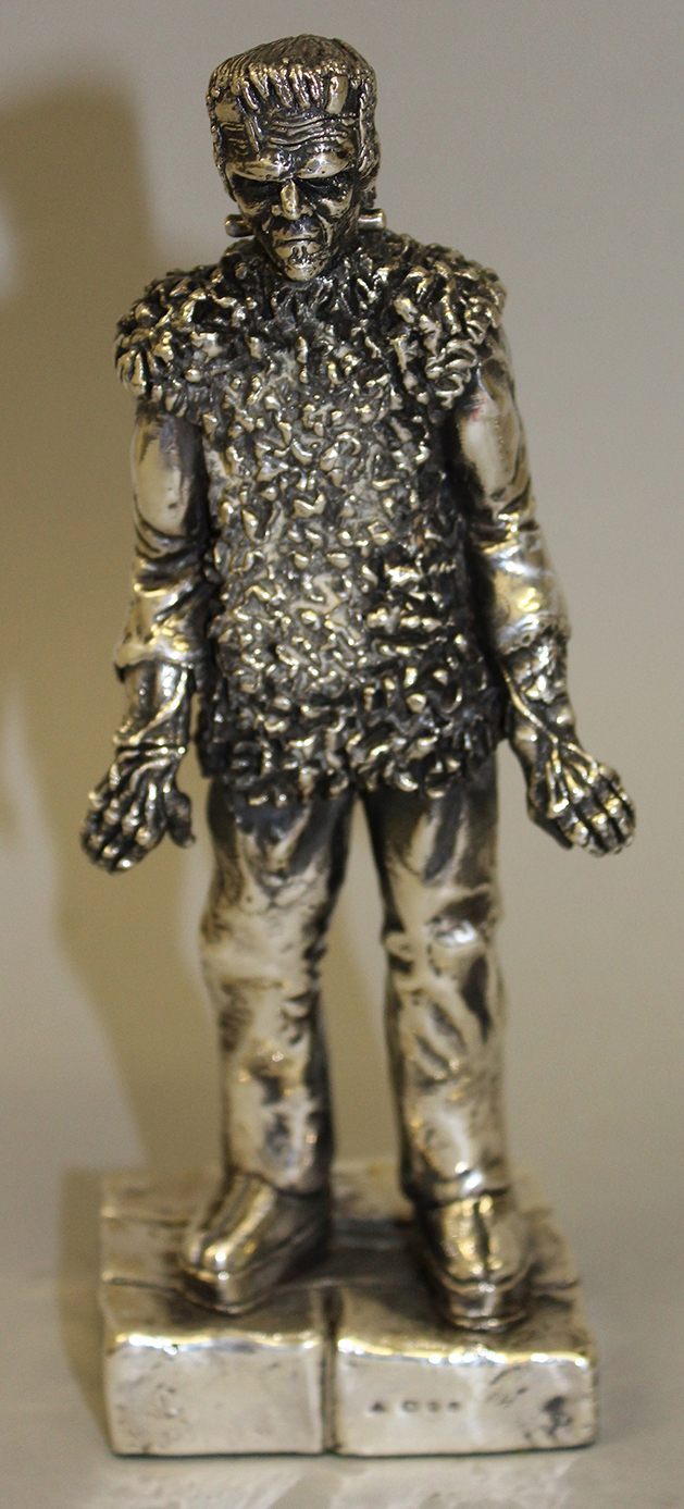 A silver model ‘Frankenstein’ signed Ray Harryhausen on white label on reverse, London Hallmark, 7 ½” high          £50 – 100