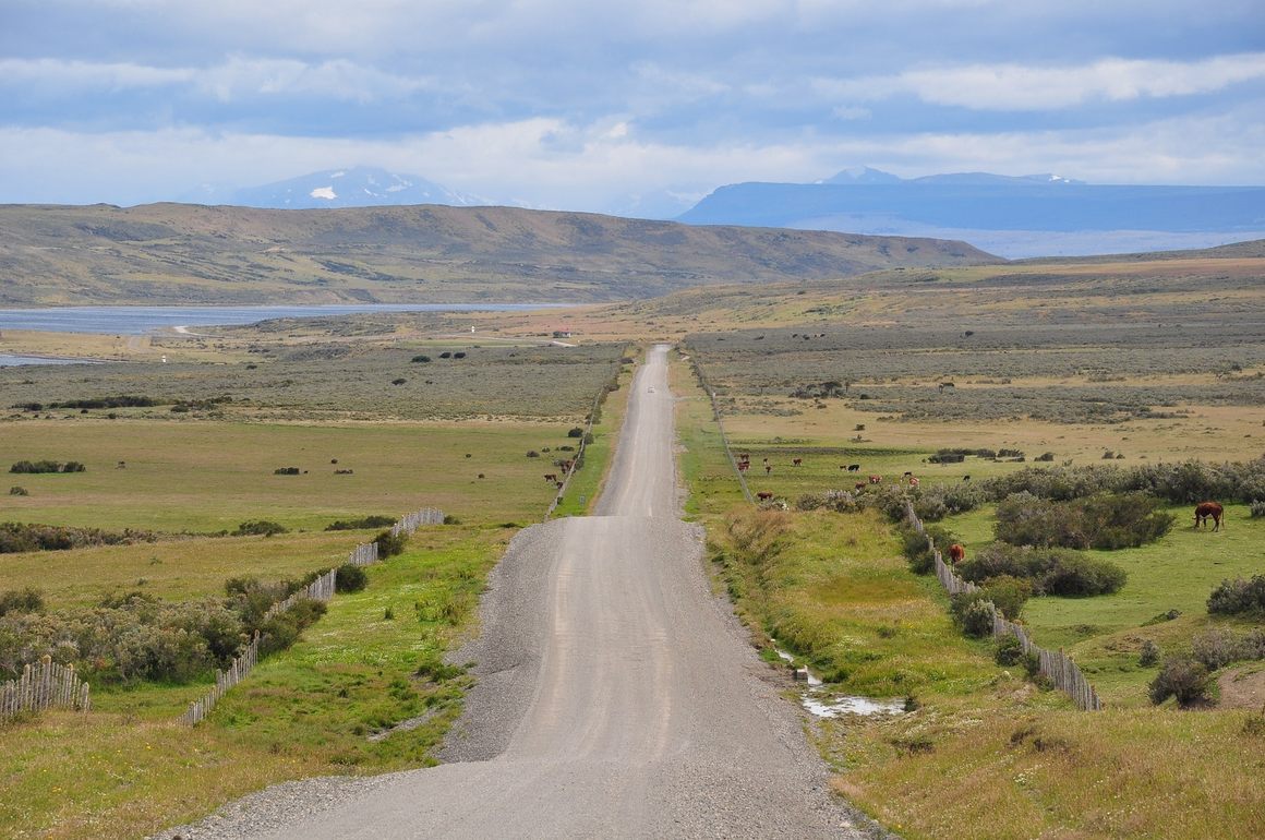 A road stretches across a valley in Patagonia.