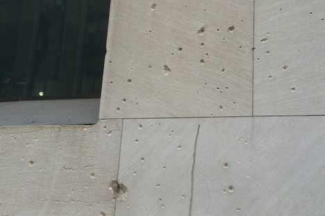 Touch a Wall Street building scarred by a 1920 terrorist bombing.