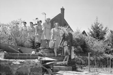 Members of a women's volunteer service in Flushing march into their Victory Garden.