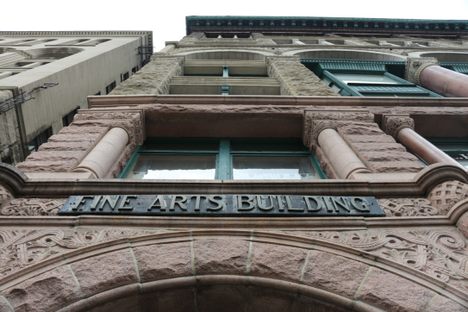 The stone above the front doorways bear the name of the Fine Arts Building.