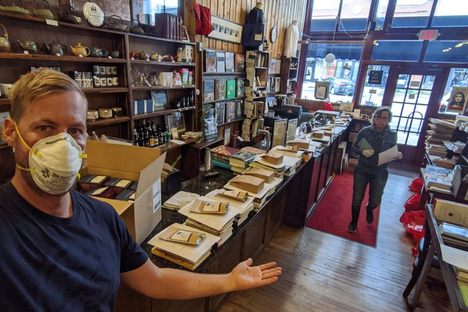 A row of "mystery bags" has taken the place of visitors browsing shelves.