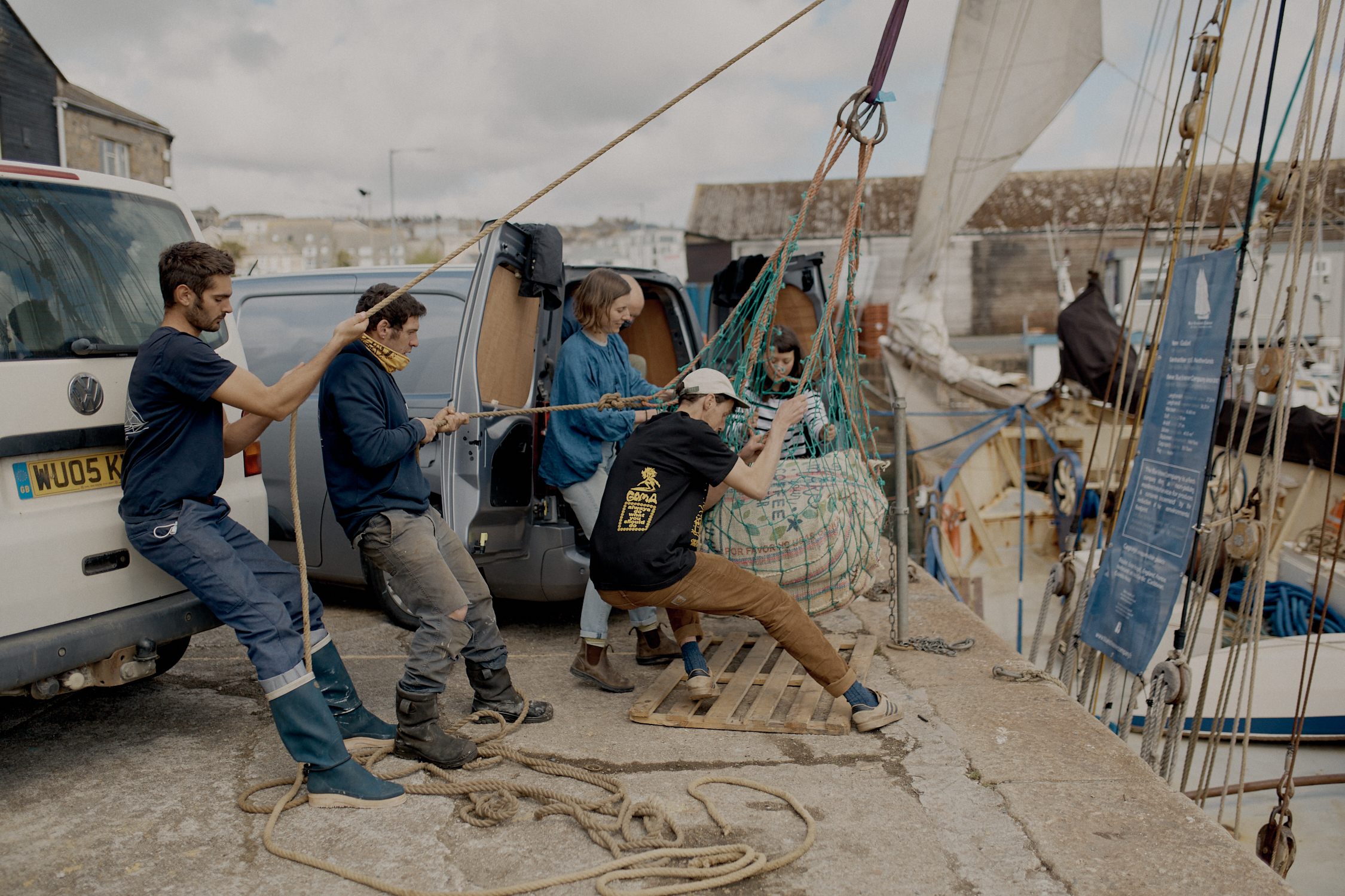 Hauling a sack of coffee onto the dock at Penzance. 