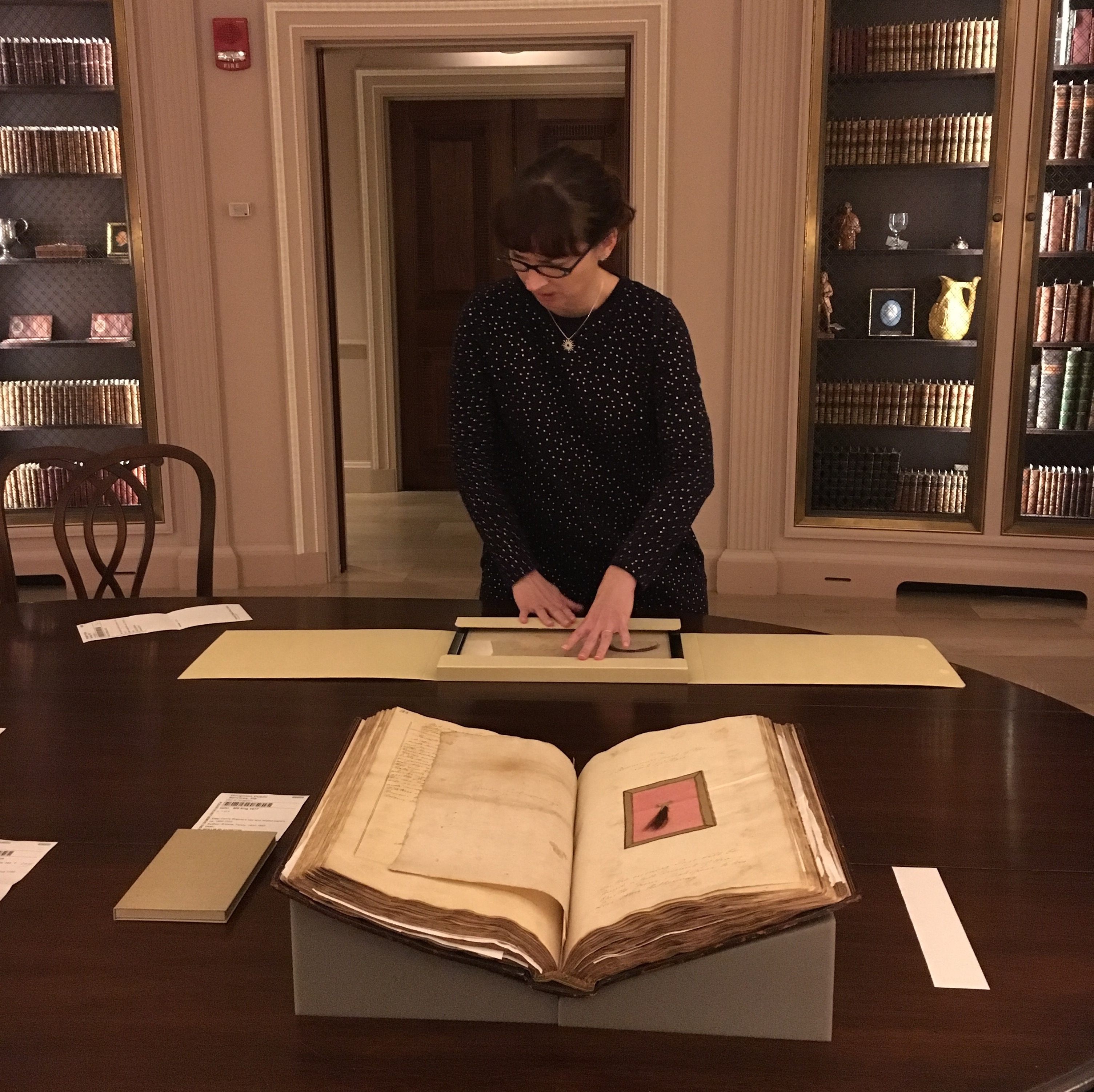 Preservation librarian Carie McGinnis reveals a hair sample from Lady Emma Hamilton, as "Shakespeare's" hair waits in the foreground.