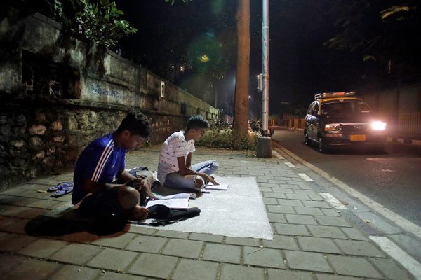 At "study corners" like Abhyas Galli, near the busy junction of Worli Naka in Mumbai, two students enjoy the peace and quiet they can't find at home. 