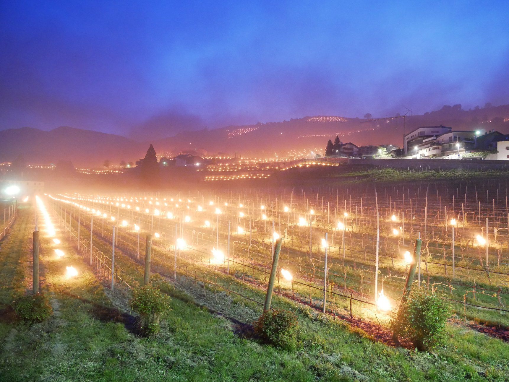 The torchlight turns the village of Novacella into a storybook scene.