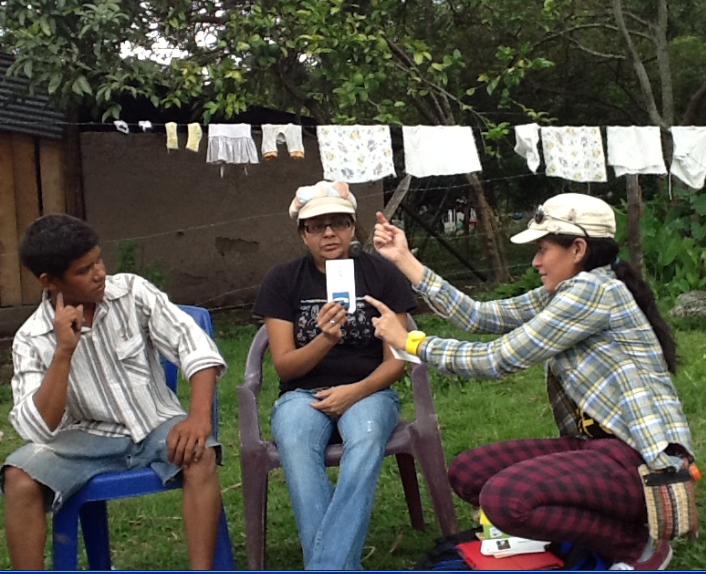 Two NSLP Deaf faculty, one from Palacagüina and another from Managua, working with a Deaf student in a rural area in the vicinity of Condega.