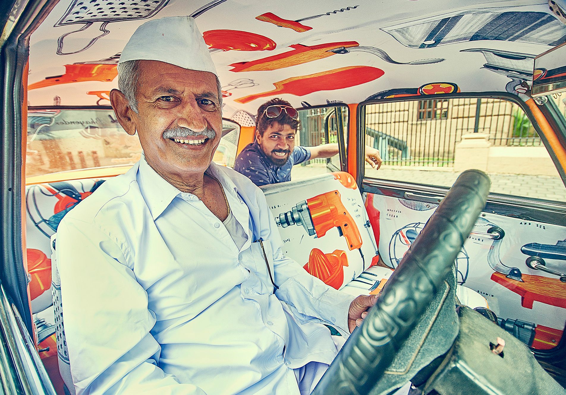 "Ever since I’ve got the Taxi Fabric, all my friends want one and the passengers can’t stop asking me about it,” said driver Dashrath Sawant, pictured here with "City of Objects," designed by Sam Kulavoor. (Photo: Taxi Fabric)