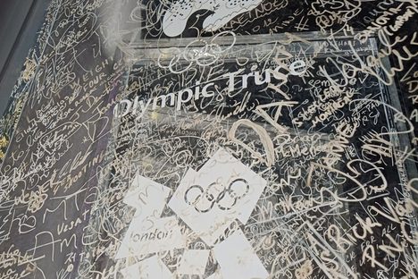 The wall is full of signatures and messages from athletes and volunteers.