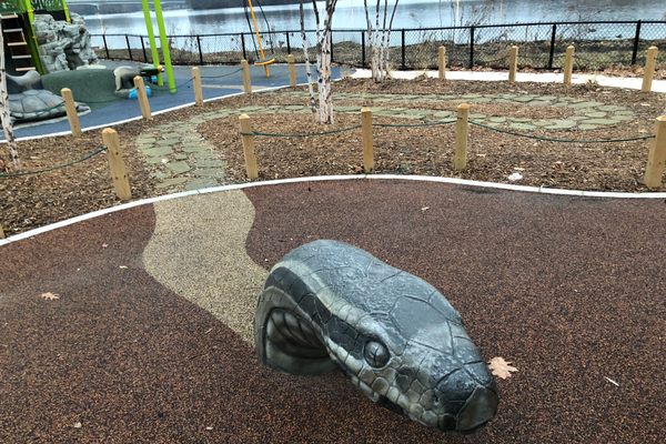 A sculpture of a Massasauga rattler in the play area.