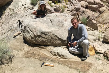 Ruby Foster and Brian Engh with the humerus in June, before it was excavated.
