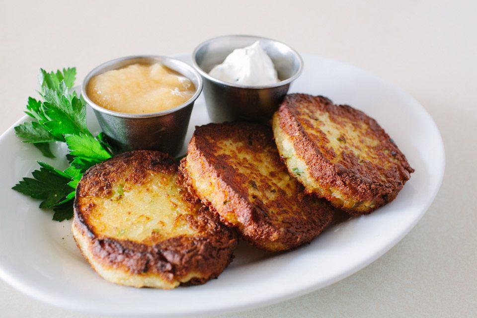 Tasty <em>kartoffelpuffer</em> potato pancakes come with applesauce and chive sour cream.
