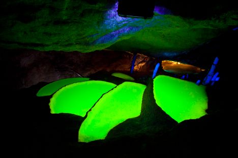 Glowing water pools in Can Marça Cave
