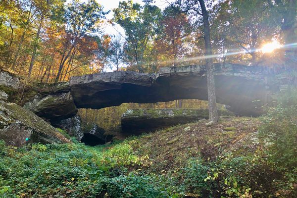 The lush, forest surroundings of the Natural Bridge of Arkansas make fall a great time to visit. 