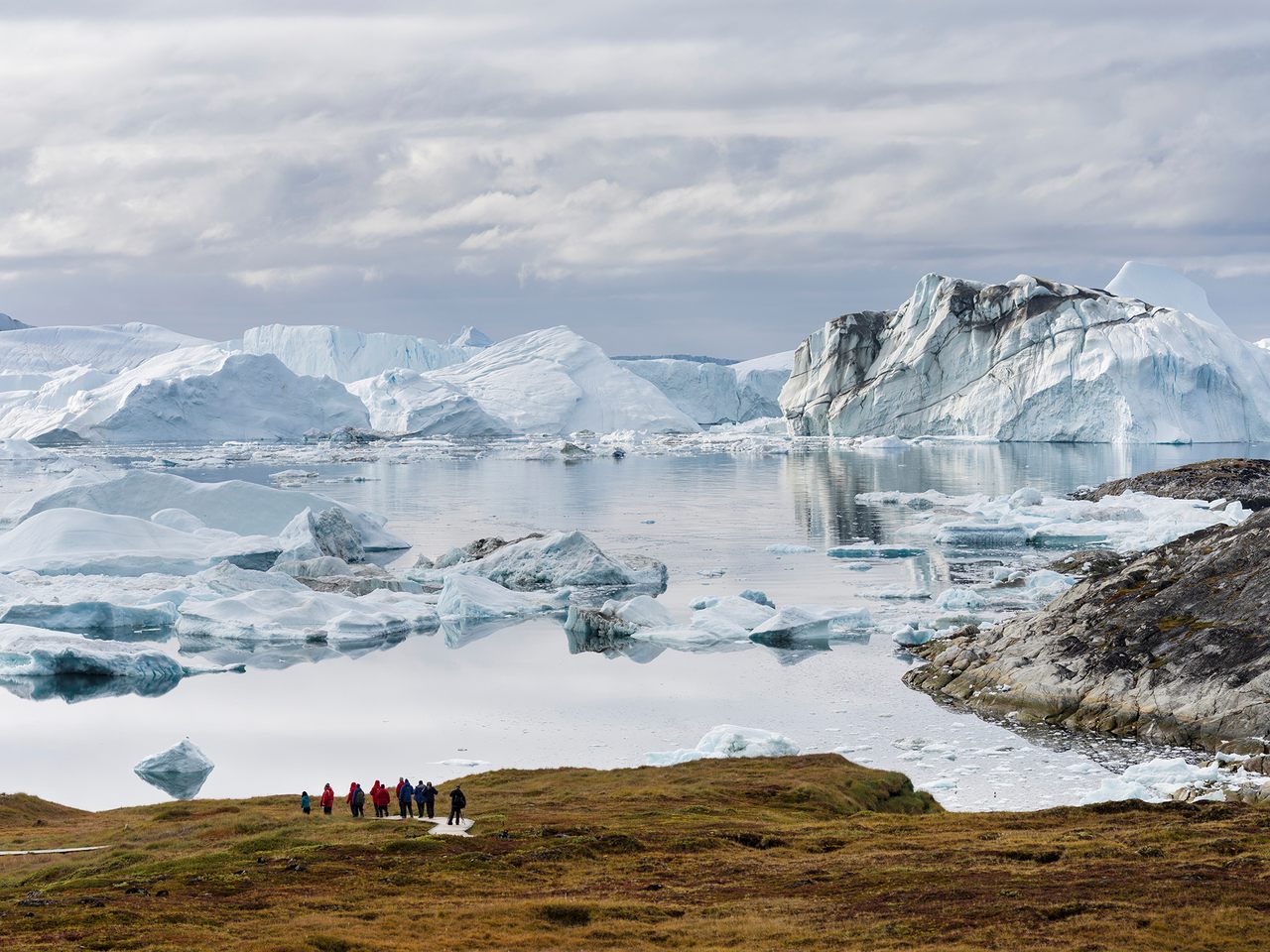 Tourists admiring the Ilulissat Icefjord.