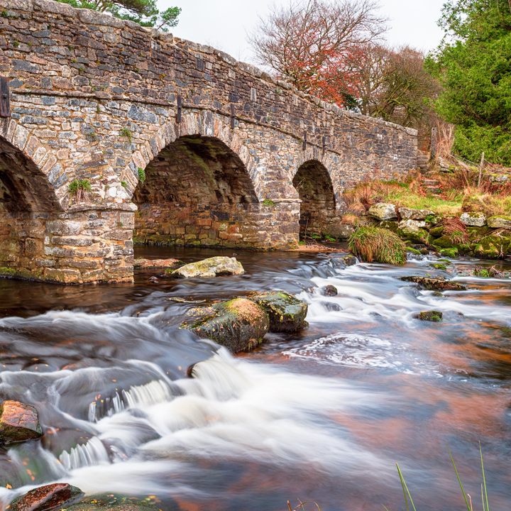 An arched bridge crossing the East Dart River