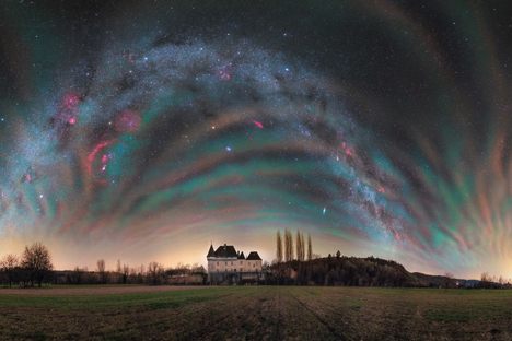 A striking example of airglow, when solar radiation energizes atoms and molecules of air, over the Château de Losse in France.