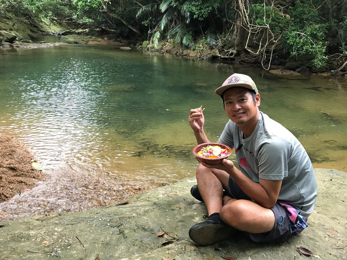 Ryusuke Matsushita eats a bowl of ramen at the foot of Pinaisara Falls.