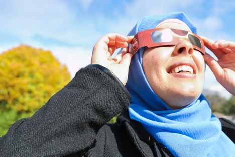 NASA/JPL Solar System Ambassador Nadia Abuisnaineh gazes up at the 2023 partial eclipse.
