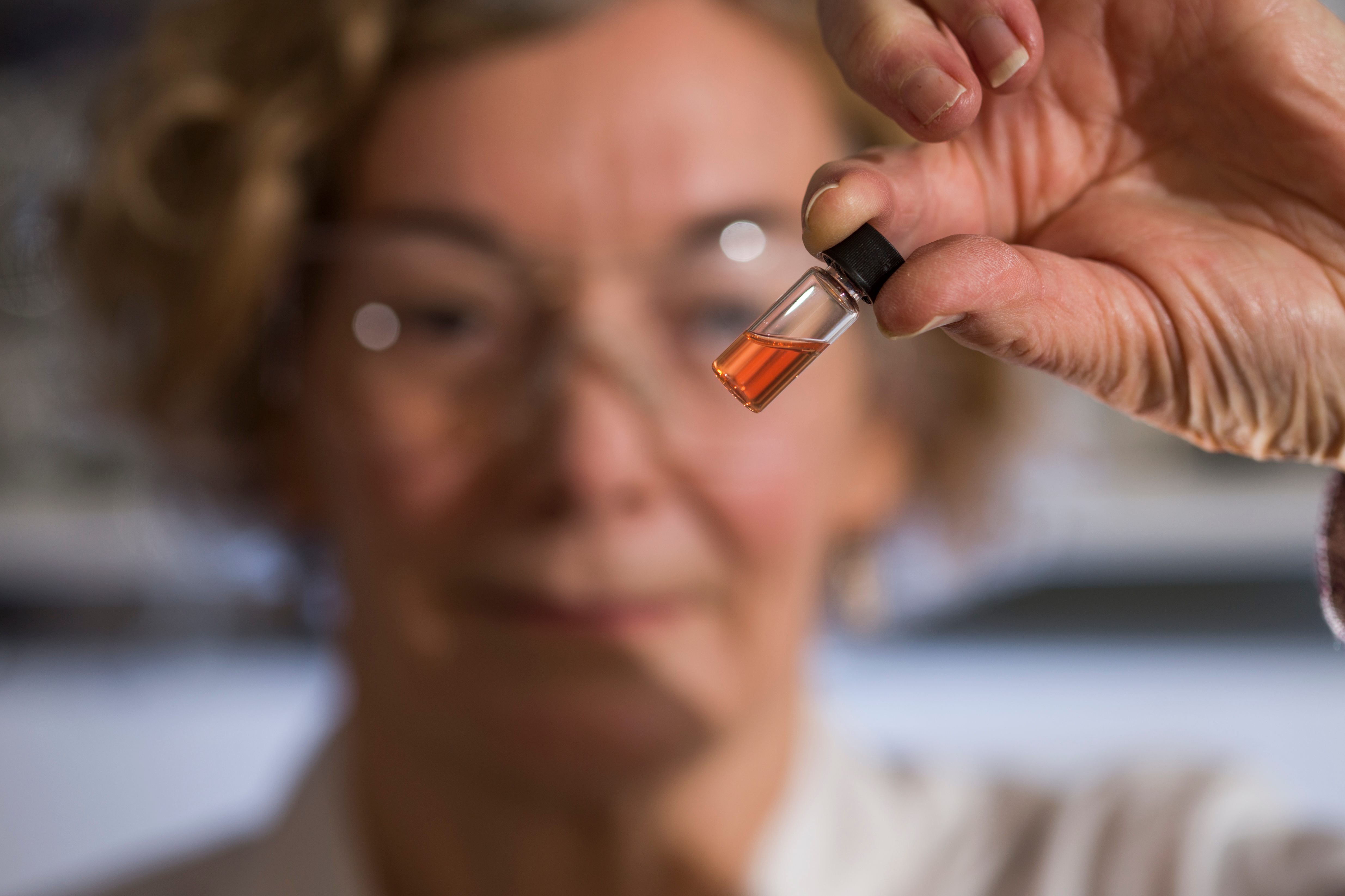 Biogeochemistry Lab Manager Janet Hope from the ANU Research School of Earth Sciences holds a vial of pigments.