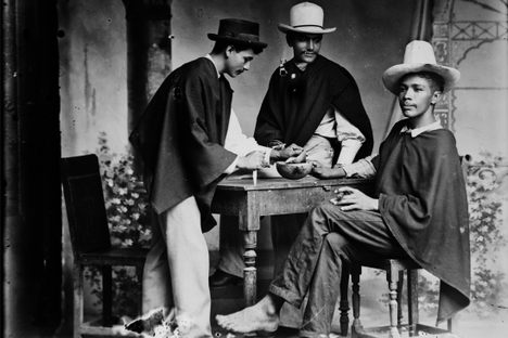 Three men enjoy chicha in Medellín, Antioquia, Colombia, in 1897.
