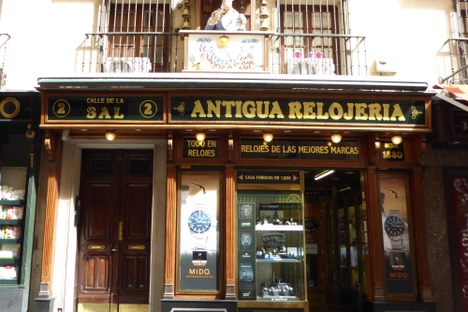 The automaton is perched above the store. 