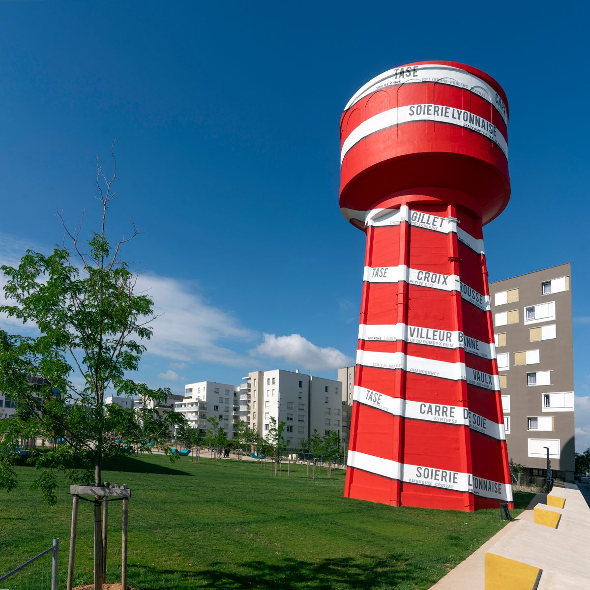 One of CitéCréation's newest works of art stands in the Vaulx-en-Velin La Soie neighborhood of Lyon. An old water-tower is painted to resemble a bobbin decorated with the names of the city’s former silk factories.