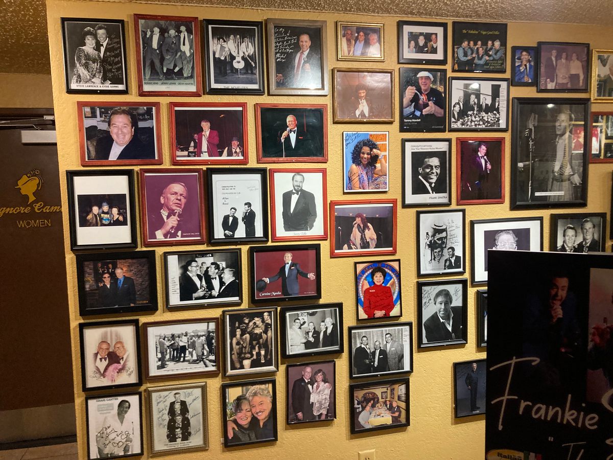 Signed photos of singers and celebrities line the walls at the Italian American Club Restaurant.