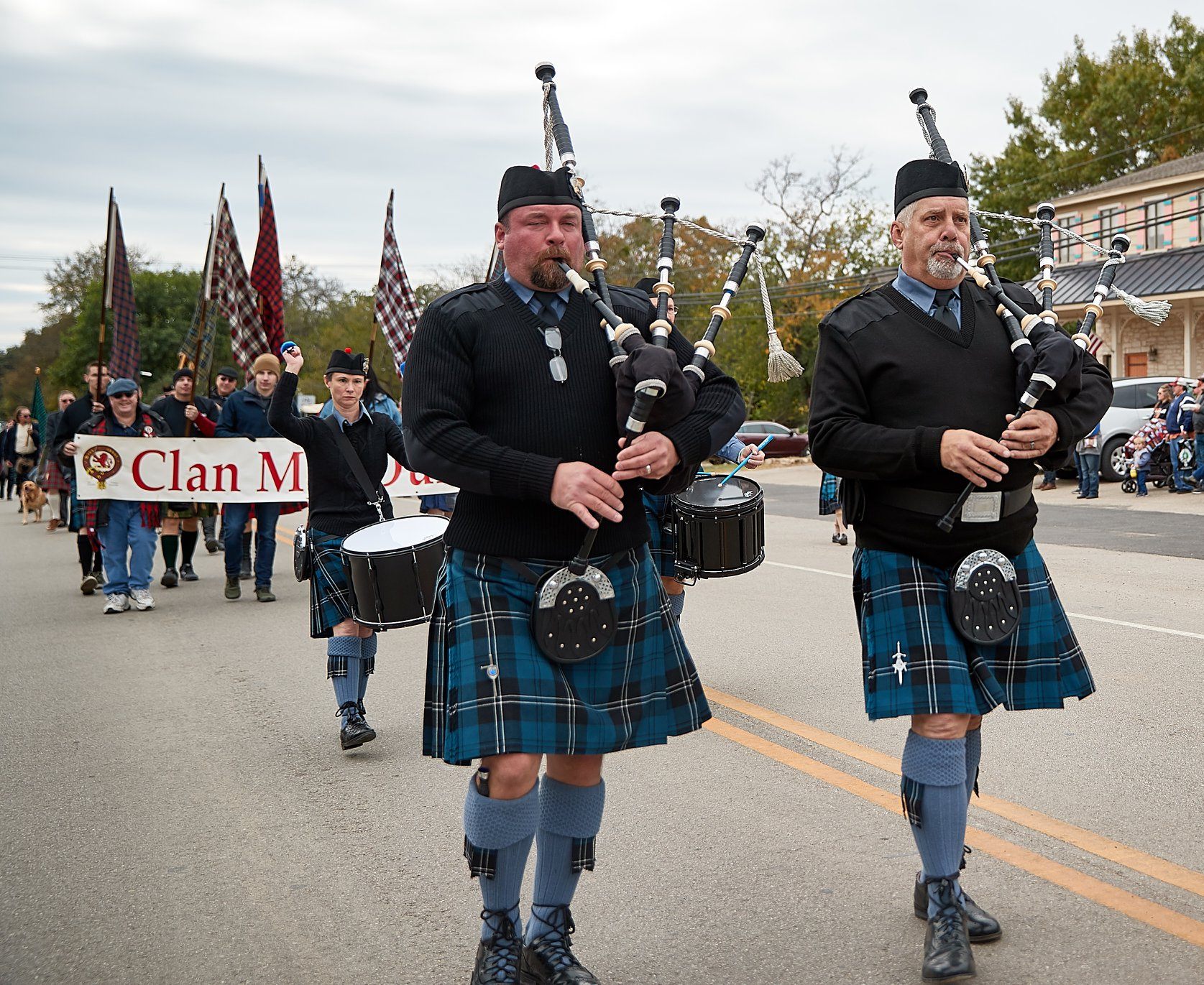 Bagpipers and drummers (and their tartans) march in the annual parade.
