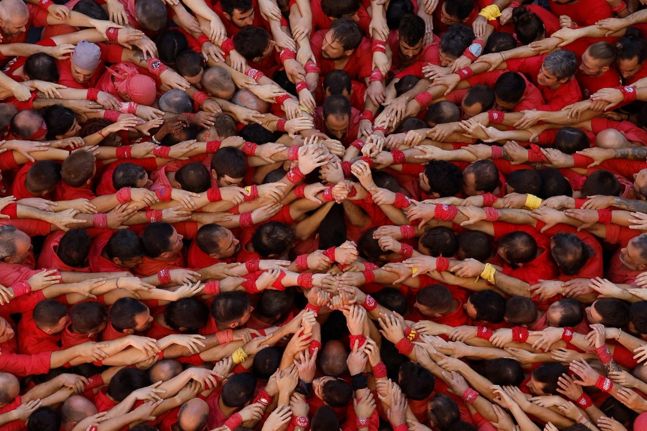 Members of Colla Joves Xiquets De Valls form the <em>pinya</em>, or foundation, of a human tower during a <em>castell</em>-building competition in Tarragona, Spain, earlier this month. 