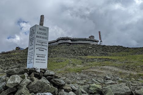 The memorial with the modern-day summit area in the background