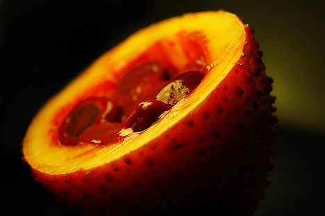 A bisected gấc fruit.