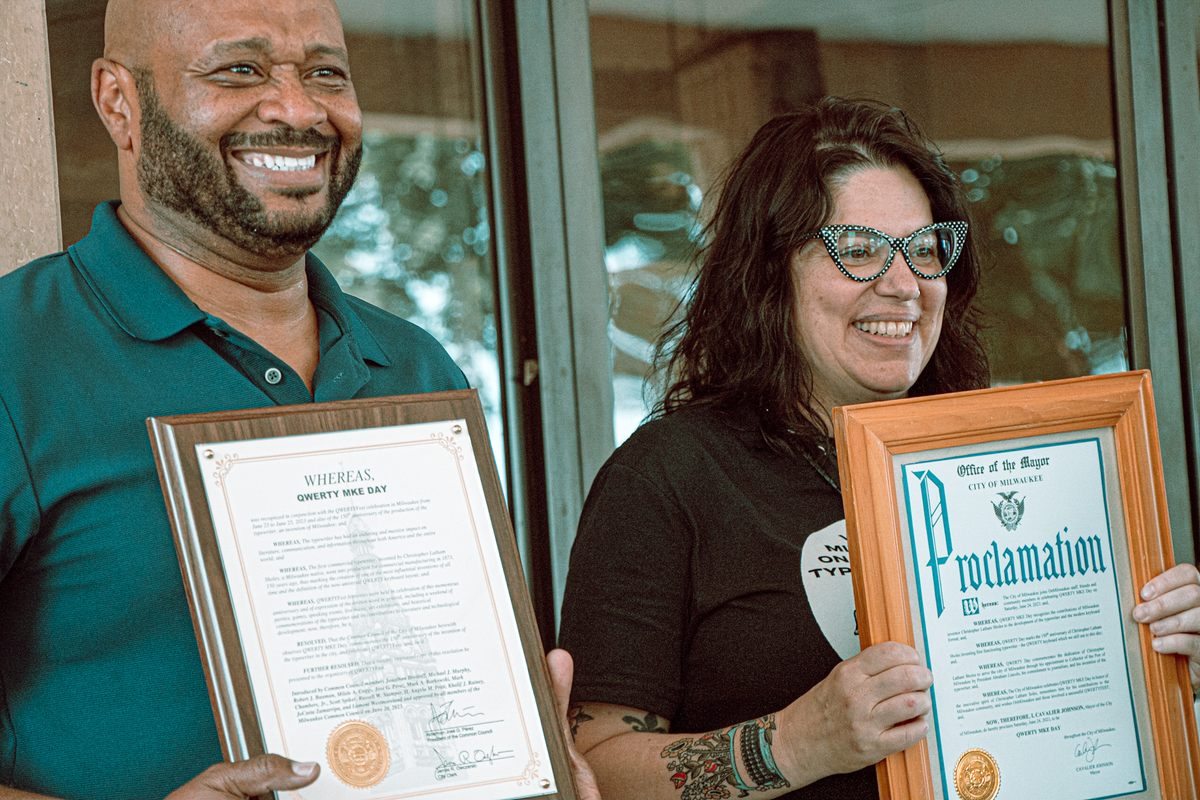 QWERTYFEST sponsor Greg Watson and co-organizer Molly Snyder pose with the official proclamation making June 24 “QWERTY MKE Day.”