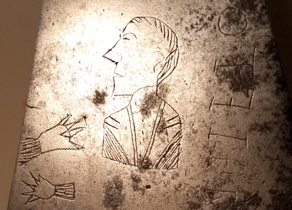 The engraving of Collins, and his hands.