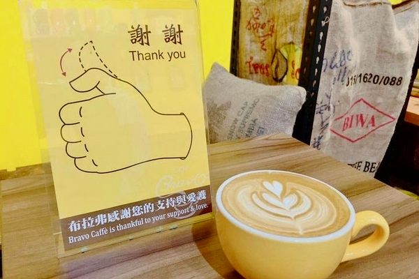 标志在布拉沃咖啡展示了如何说“谢谢”在台湾手语。