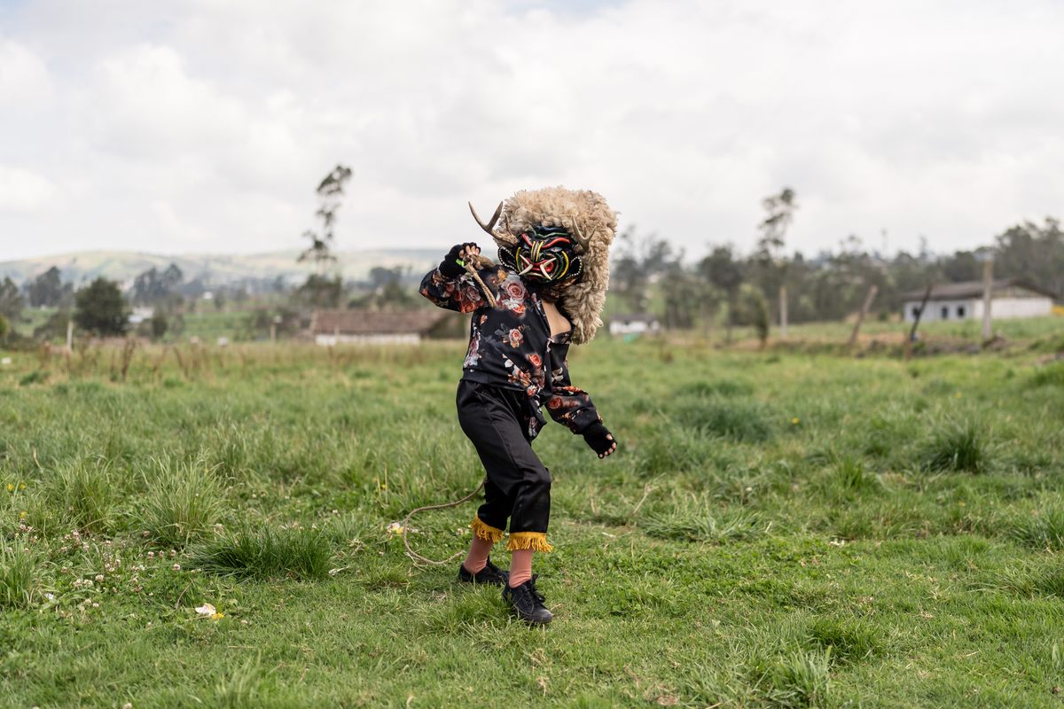 Carlitos Lara, 8, shows off his devil mask and dance in Tunguipamba, on the outskirts of Píllaro, Ecuador, on the first day of the Diablada of 2023. His mask features real deer antlers, boar's teeth, and sheep skin.