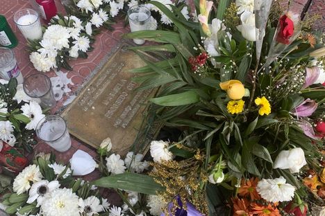 Flowers at the plaque in 2021.