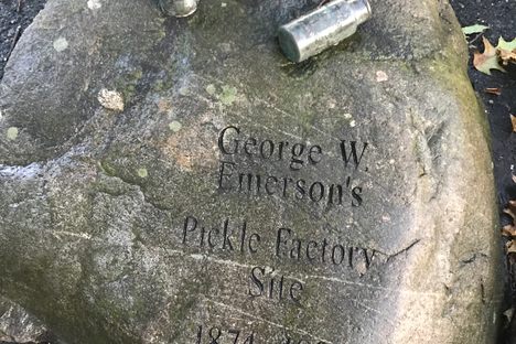 The stone marker, with replicas of the company's original jars.