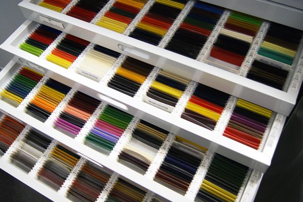 Drawers of samples of dried paint on glass slides.