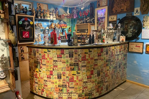 Every tour begins in the basement, featuring a bar decorated in Russian vodka labels.