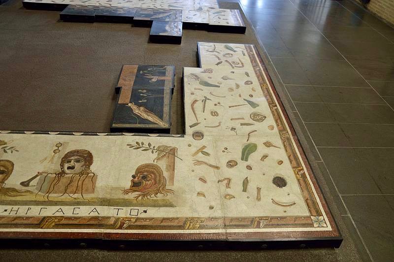 The "unswept room" motif is accompanied by a design with theatrical masks and a central Nile scene.
